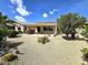 Expansive desert landscaped backyard with covered patio and outdoor seating at 172 S Agua Fria Ln, Casa Grande, AZ 85194