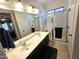 Bathroom featuring double sinks and a tiled shower at 172 S Agua Fria Ln, Casa Grande, AZ 85194