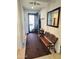 Entryway featuring tile floors, coat hooks, a bench, and a view of the front door at 172 S Agua Fria Ln, Casa Grande, AZ 85194