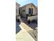Inviting front porch with brick pavers, desert plants, and a decorative metal art piece on the wall at 172 S Agua Fria Ln, Casa Grande, AZ 85194