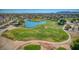 Picturesque golf course featuring a tranquil pond, manicured green, and meandering cart paths at 172 S Agua Fria Ln, Casa Grande, AZ 85194
