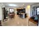 Spacious kitchen with an island, dark cabinets, tile floors, and a dining area at 172 S Agua Fria Ln, Casa Grande, AZ 85194