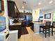 Well-lit kitchen featuring stainless appliances, dark cabinets, and a center island at 172 S Agua Fria Ln, Casa Grande, AZ 85194