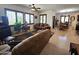 Living room area featuring tile floors, a ceiling fan and large windows at 172 S Agua Fria Ln, Casa Grande, AZ 85194