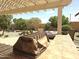 Outdoor patio with tiled flooring, seating area, and landscaped backyard at 172 S Agua Fria Ln, Casa Grande, AZ 85194