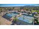 Aerial view of community tennis courts surrounded by lush landscaping and residential homes at 172 S Agua Fria Ln, Casa Grande, AZ 85194
