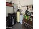 Utility room featuring water heater and water softener at 172 S Agua Fria Ln, Casa Grande, AZ 85194