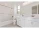 Well-lit bathroom with double sinks, white cabinetry, and a bathtub with white tile at 18508 E Dario Rd, Gold Canyon, AZ 85118