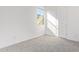 Bright bedroom featuring neutral carpeting, a window, and a white door at 18508 E Dario Rd, Gold Canyon, AZ 85118
