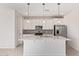 Bright kitchen with white cabinets, an island with pendant lighting, stainless steel appliances and tiled backsplash at 18508 E Dario Rd, Gold Canyon, AZ 85118