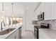 A modern kitchen with stainless steel appliances, white cabinetry and an island overlooking the backyard at 18508 E Dario Rd, Gold Canyon, AZ 85118