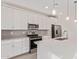 This kitchen has modern white cabinets, stainless steel appliances, backsplash, and an island with a sink at 18508 E Dario Rd, Gold Canyon, AZ 85118