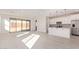 Open-concept layout connecting living space and kitchen with stainless appliances, island, and sliding glass doors at 18508 E Dario Rd, Gold Canyon, AZ 85118