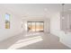 Bright and spacious living area with neutral tile flooring, recessed lighting, and sliding door access to backyard at 18508 E Dario Rd, Gold Canyon, AZ 85118