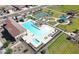 Aerial view of community featuring sparkling pool, playground, tennis courts, and green spaces at 19360 N Diego Way, Maricopa, AZ 85138