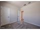 An airy bedroom with neutral walls and carpet flooring at 19360 N Diego Way, Maricopa, AZ 85138