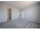 Spacious bedroom featuring a walk-in closet and neutral color scheme at 19360 N Diego Way, Maricopa, AZ 85138