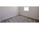 Bedroom with neutral walls, carpet flooring, and a window providing natural light at 19360 N Diego Way, Maricopa, AZ 85138