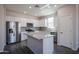 Modern kitchen featuring stainless steel appliances, granite countertops, and a kitchen island at 19360 N Diego Way, Maricopa, AZ 85138