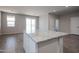 Close-up of kitchen island with granite countertop and white cabinets at 19360 N Diego Way, Maricopa, AZ 85138