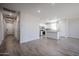 Open-concept living space featuring tile floors, recessed lighting, and a partial kitchen view at 19360 N Diego Way, Maricopa, AZ 85138