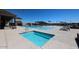 Community pool area featuring hot tub, lounge chairs, and covered seating with clear blue sky at 19360 N Diego Way, Maricopa, AZ 85138
