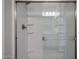Modern shower with glass doors and built-in shelving for convenience at 19360 N Diego Way, Maricopa, AZ 85138