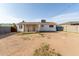 Large, empty backyard featuring dirt space, covered patio, and fence at 2019 W Wayland Rd, Phoenix, AZ 85041
