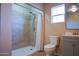 This bathroom features a shower with tile surround, a toilet, and a vanity with a sink at 2019 W Wayland Rd, Phoenix, AZ 85041