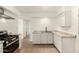 Spacious kitchen with white cabinets, granite countertops, stainless steel appliances, and tile flooring at 2019 W Wayland Rd, Phoenix, AZ 85041