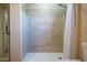 Close-up of the shower with tile surround and neutral color scheme at 2019 W Wayland Rd, Phoenix, AZ 85041