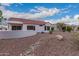 Charming home featuring a well-maintained backyard with decorative rock and desert landscaping at 20301 N Queen Palm Ln, Surprise, AZ 85374