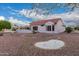 A wide backyard featuring desert landscaping with privacy and a tiled roofline at 20301 N Queen Palm Ln, Surprise, AZ 85374