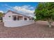 Charming home featuring a well-maintained backyard with decorative rock and desert landscaping at 20301 N Queen Palm Ln, Surprise, AZ 85374