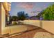 A peaceful covered patio with a landscape view and a decorative desert garden at 20301 N Queen Palm Ln, Surprise, AZ 85374