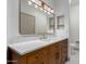 Modern bathroom boasts a granite vanity, and sleek rectangular mirror at 20301 N Queen Palm Ln, Surprise, AZ 85374