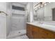 Stylish bathroom features a marble shower, granite vanity, and modern lighting at 20301 N Queen Palm Ln, Surprise, AZ 85374