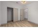 Neutral bedroom has wood-look floors and a closet at 20301 N Queen Palm Ln, Surprise, AZ 85374