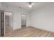 Bright bedroom with wood-look floors, ceiling fan, and walk-in closet is move-in ready at 20301 N Queen Palm Ln, Surprise, AZ 85374