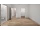 Empty bedroom with two open doorways to the bathroom and closet at 20301 N Queen Palm Ln, Surprise, AZ 85374
