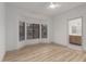 Empty bedroom features bay window and ensuite bathroom with modern fixtures at 20301 N Queen Palm Ln, Surprise, AZ 85374