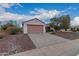 Charming single-story home with a two-car garage and beautiful desert landscaping at 20301 N Queen Palm Ln, Surprise, AZ 85374