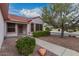 Inviting front entrance with security door, desert landscaping, and manicured shrubbery at 20301 N Queen Palm Ln, Surprise, AZ 85374