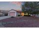 Charming home with well-maintained front yard with mature landscaping and desert rock features at 20301 N Queen Palm Ln, Surprise, AZ 85374