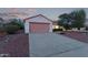 Single-story home with a two-car garage, desert landscaping, and a welcoming entryway at 20301 N Queen Palm Ln, Surprise, AZ 85374