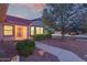 Charming home featuring a well-manicured yard, mature tree, and a cozy entryway, perfect for a welcoming touch at 20301 N Queen Palm Ln, Surprise, AZ 85374