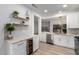 Bright kitchen featuring stainless steel appliances, white cabinetry, and stylish light fixtures at 20301 N Queen Palm Ln, Surprise, AZ 85374