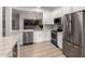 Open kitchen boasts stainless appliances, quartz countertops, and white cabinets for a sleek design at 20301 N Queen Palm Ln, Surprise, AZ 85374