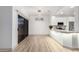 Contemporary living space featuring modern fixtures, stylish flooring, and a view of the kitchen at 20301 N Queen Palm Ln, Surprise, AZ 85374