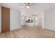 Spacious living room offering views of the modern kitchen, stylish floors, and abundant natural light at 20301 N Queen Palm Ln, Surprise, AZ 85374